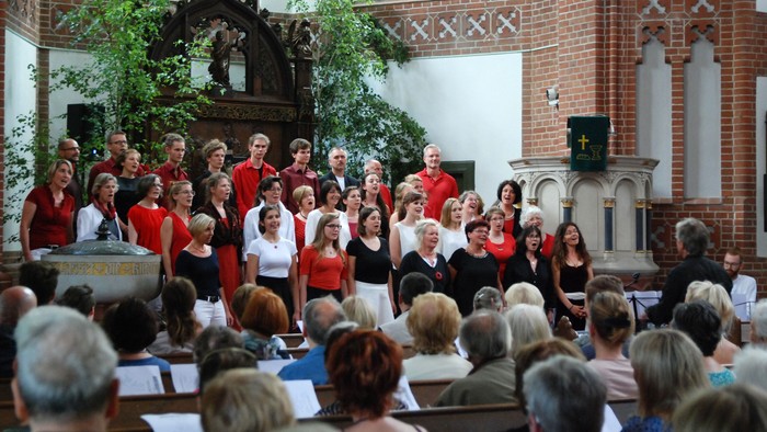 Ein Chor singt in einer Kirche vor einem Publikum