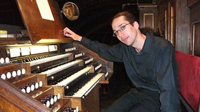 Mann spielt Orgel in Kirche