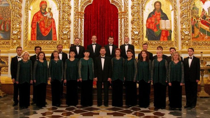En gruppe korister poser i en prægtig kirke.
