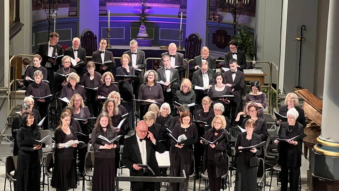 Large choir performing in grand church setting