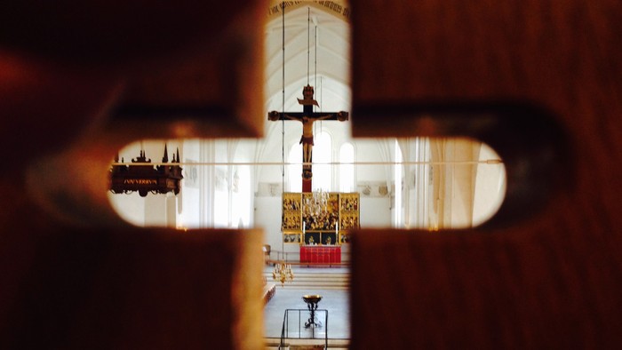 Et kors med Jesus på korset set gennem et håndtag.