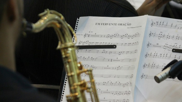 En saksofonist spiller og ser på noter