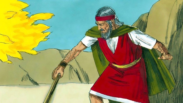 En gammel mand med hvid skæg bærer en stav i ørkenen