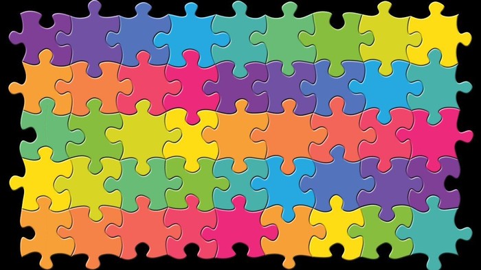 Bunte Puzzleteile in einem Rahmen angeordnet