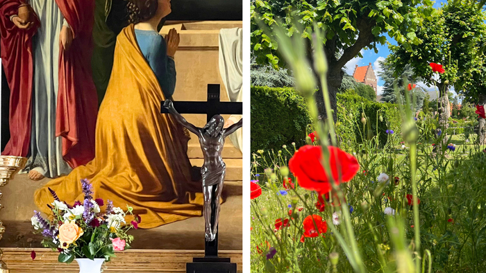 Billedet viser en religiøs statue og en blomsterhave med røde valmuer