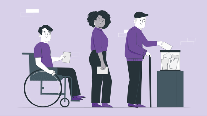 Drei Personen in einem Büro, eine im Rollstuhl, eine am Laptop, eine am Drucker.