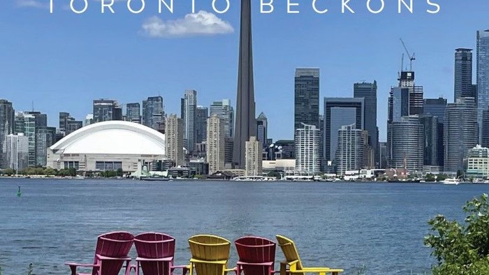 Toronto skyline with CN Tower, colorful chairs, and meeting place info