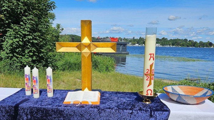 Ein goldenes Kreuz und Kerzen auf einem Altar vor der Havel