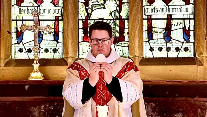 Man in religious attire praying in church