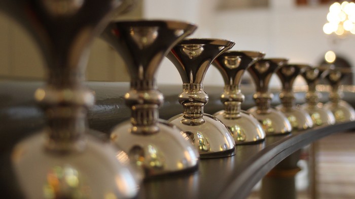 En rekke glansende martiniglas på bord.