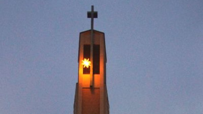 Der Glockenturm einer Kirche bei Dämmerung