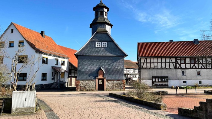 Kleiner Marktplatz mit historischen Gebäuden und einer Kirche.