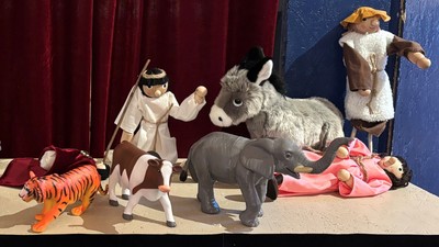 Et dukketeater opsat i en ørkenscene med forskellige karakterer på scenen.
