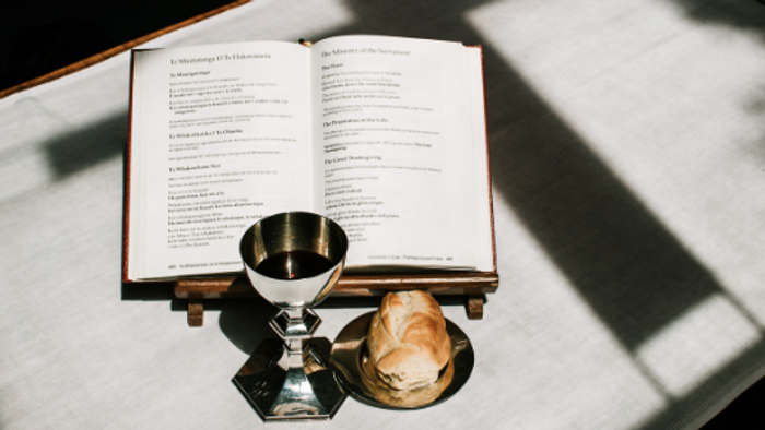 Open Bible with chalice and candles, BCP Service of Holy Communion