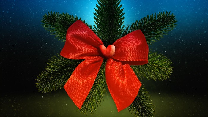 En grøn kvist med rød bue og en hjerteformet lyse.