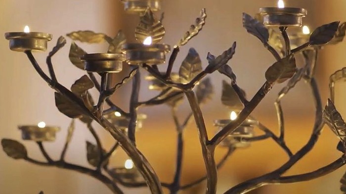 En smuk kandleholder med blomster og lys.