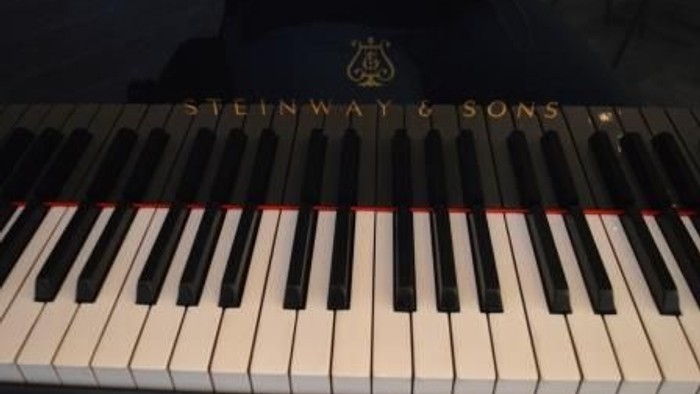 Et sort piano med hvidt nøglebord og