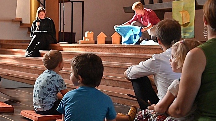 Kinder und Erwachsene nehmen an einer religiösen Feier in einer Kirche teil