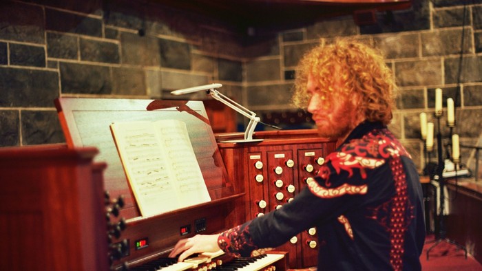 Woman playing organ in stone building