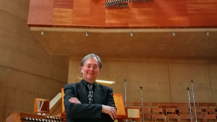 Man standing in front of organ