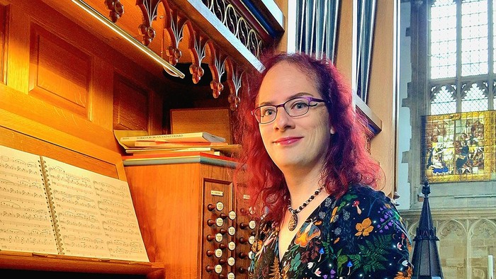 Woman sitting at organ in church
