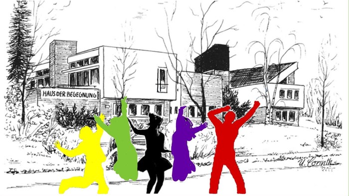 Vier bunte Figuren tanzen vor einem Haus im Schnee