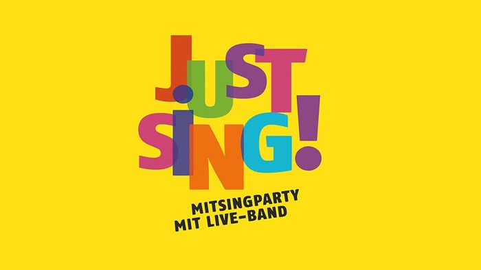 Bunter Schriftzug "Just Sing!" vor gelbem Hintergrund