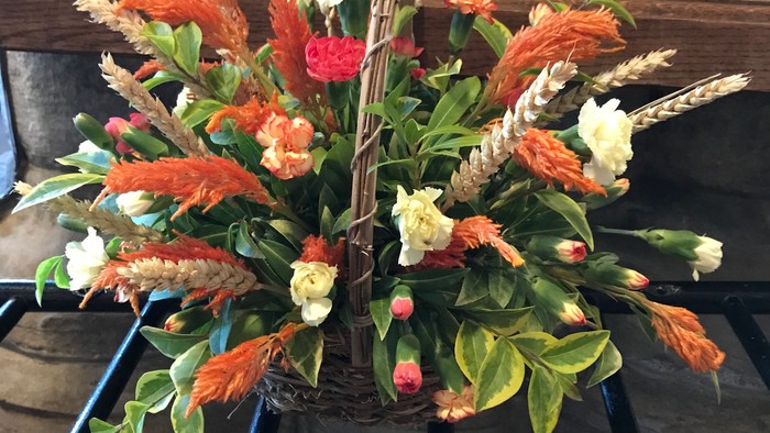 Vibrant floral arrangement on a table with books in background