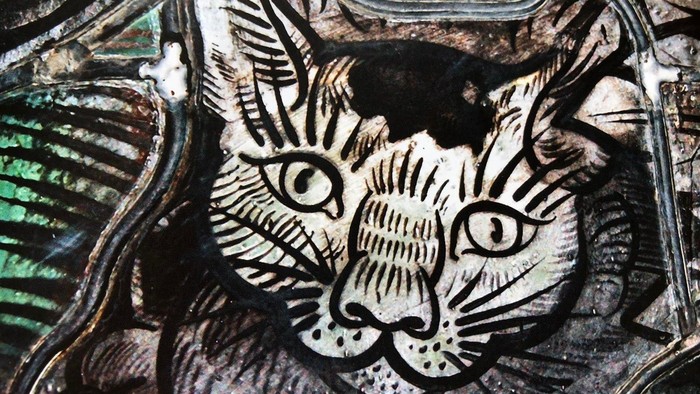 Das Bild zeigt eine detaillierte Holzschnittdarstellung eines Katzenkopfes.