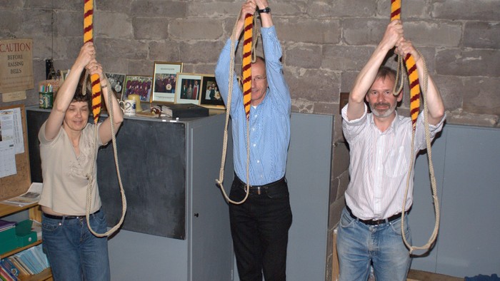 Three bellringers about to start ringing the Cahtedral bells