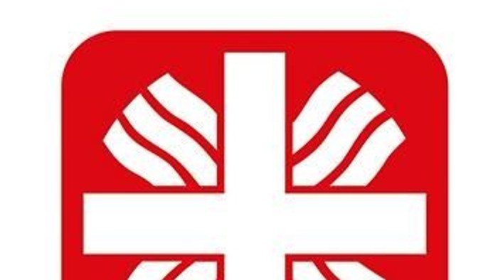 Rotes Logo mit einem Kreuz-Emblem und dem Wort „caritas“ in fetten, kleingeschriebenen Buchstaben.