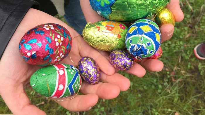 En person holder en håndfuld bunte og pyntede ostereier.