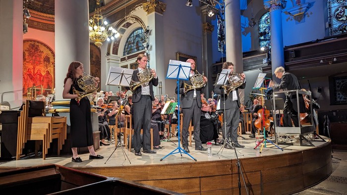Musicians perform in ornate church setting