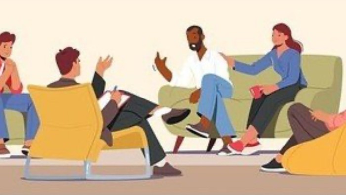 En gruppe af mennesker sidder i en sirkel og deltager i en diskussion.