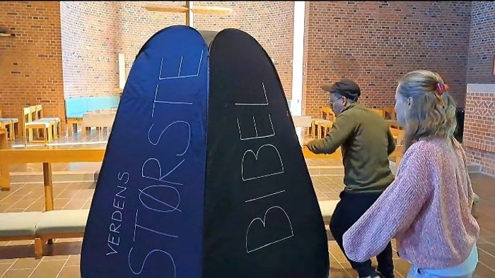 To børn står foran store blå og sorte billeder med teksten 