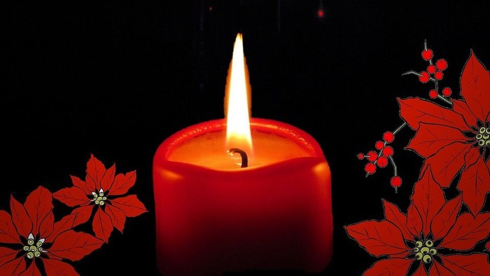 En rød lysende lysstake med røde poinsettier på en mørk baggrund