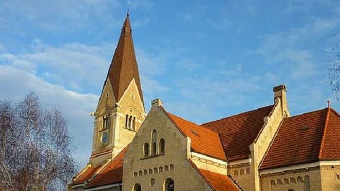 Gammel kirke med spiret og røde tag.