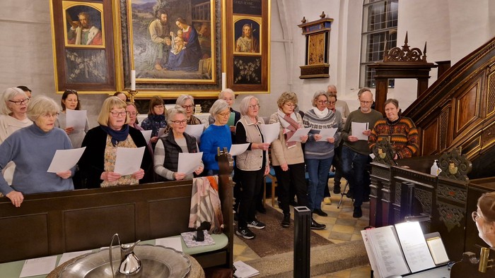 En gruppe kvinder synger i en kirke