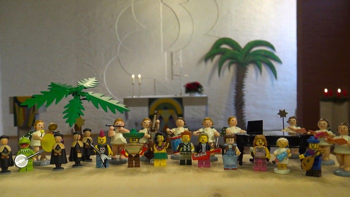 Eine Gruppe von Lego-Minifiguren in tropischer Umgebung mit Palmen und Strandaccessoires.