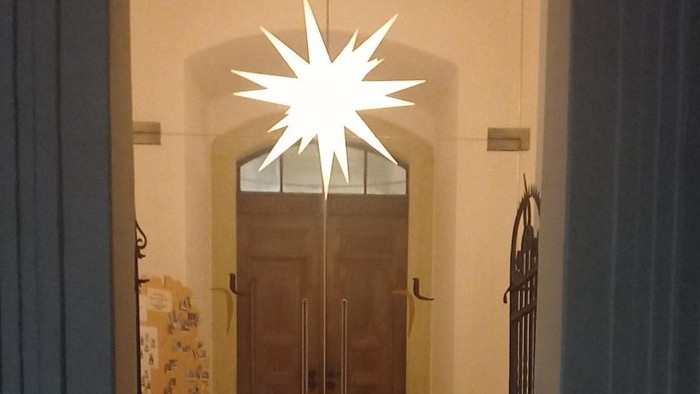 Weihnachtliche Eingangstür mit Stern und Kerzen