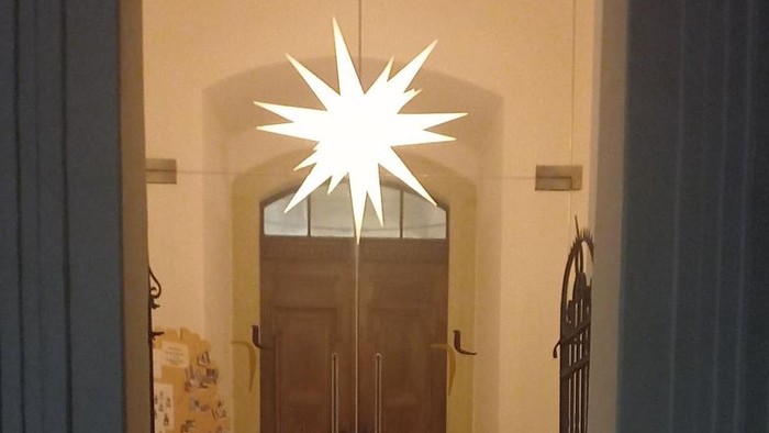 Weihnachtliche Eingangstür mit Stern und Kerzen