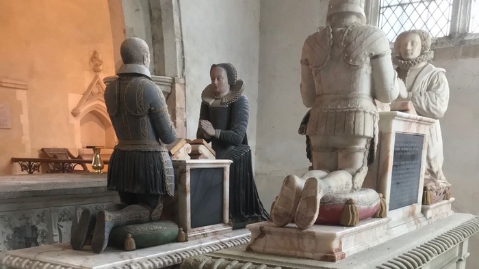 Stone tombs with statues in a church.