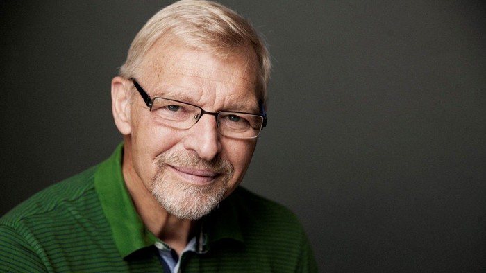 Mand med briller iført grøn skjorte.