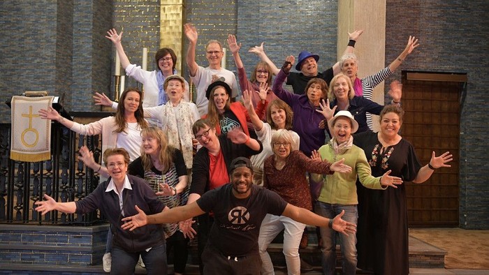 Eine Gruppe von Menschen feiert auf einer Bühne