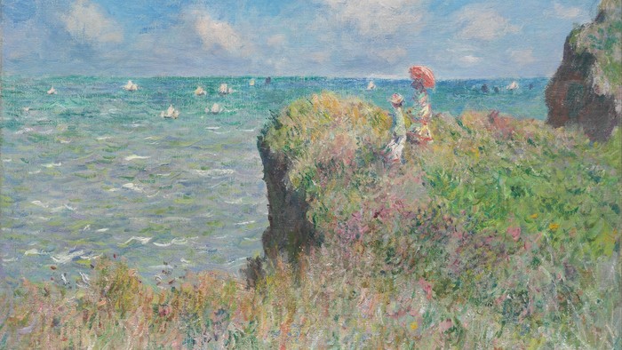 Grüner Felsen mit Blick auf das Meer