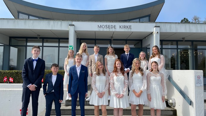 En gruppe ungdomme og drenge poserer på træerne til Mosede Kirke