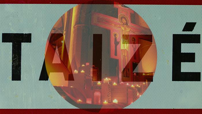 Das Bild zeigt eine Kirche mit einem großen Kreuz und Kerzen.