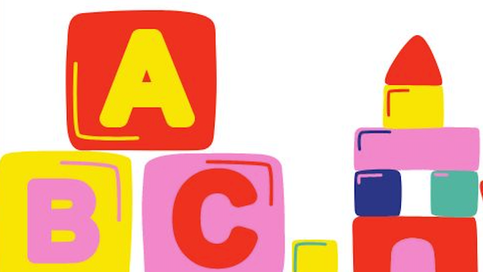 Bunte Bauklötze mit Buchstaben und Zahlen, teilweise zu einem Turm gestapelt