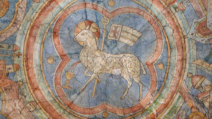 Das Bild zeigt eine detaillierte Darstellung eines Lamm-Mosaiks in einem kreisförmigen Rahmen
