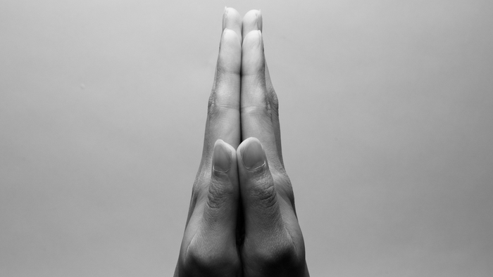 Hände in einer Gebets- oder Meditationsgeste gefaltet.